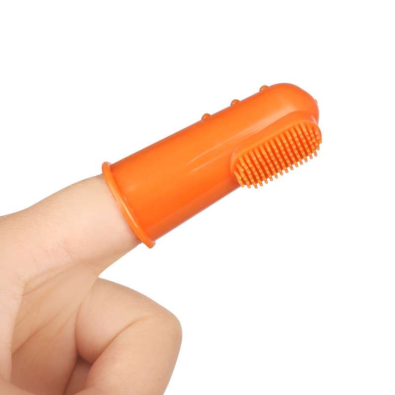 Finger toothbrush in orange with soft bristles for dog dental care, designed for easy use.