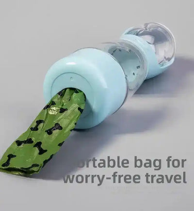 Light blue cylindrical dispenser with clear chamber, holding a green patterned bag protruding out | PicSEO 1786063227445