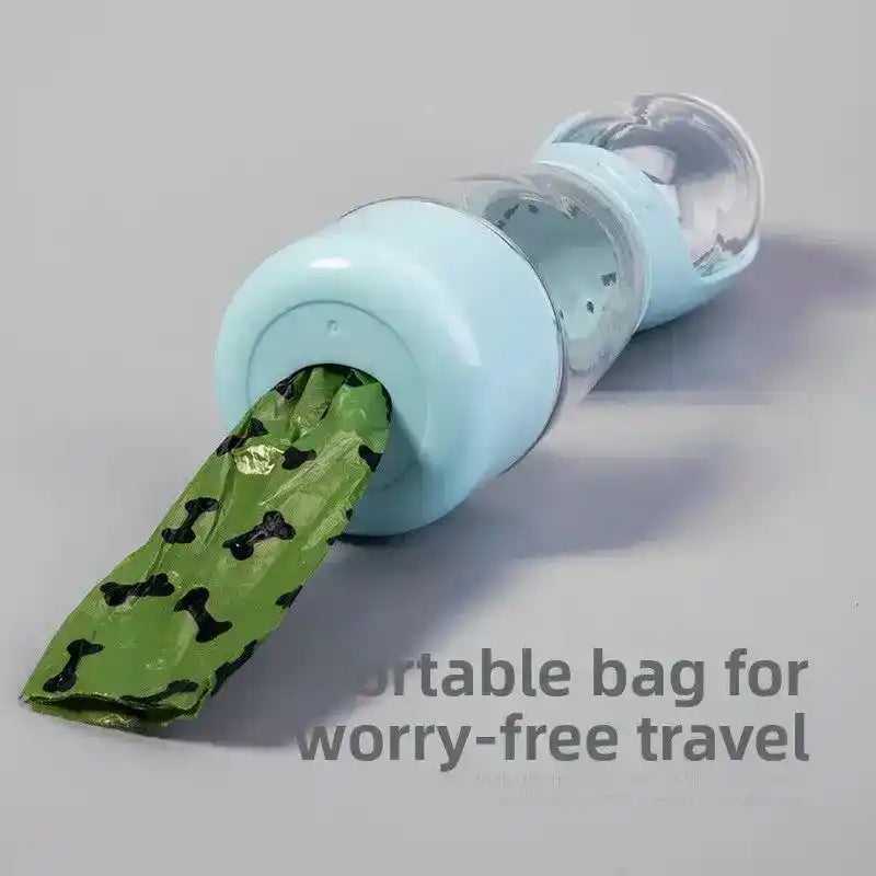Light blue cylindrical dispenser with clear chamber, holding a green patterned bag protruding out | PicSEO 1786063227445