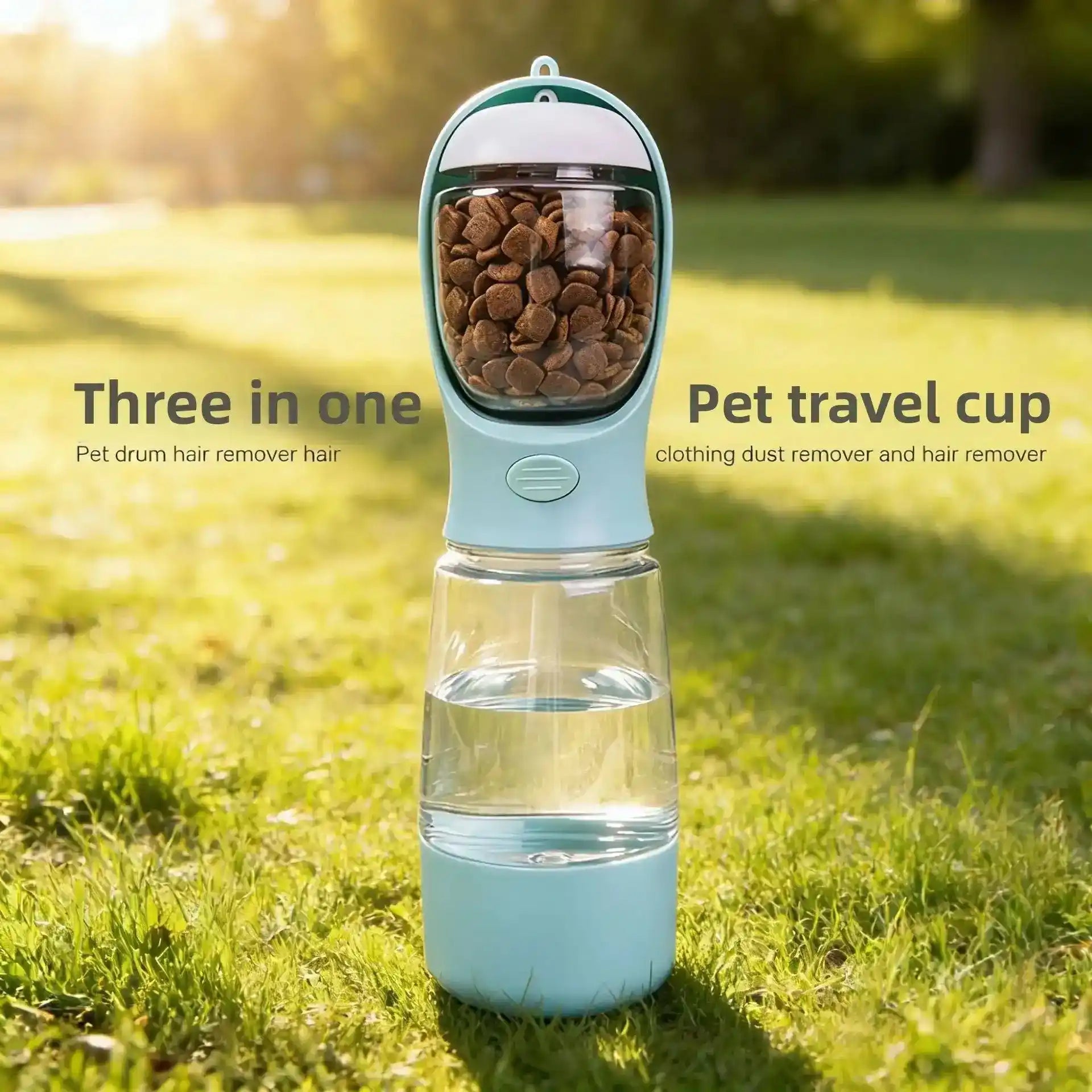 Light blue pet travel cup with clear lower chamber filled with brown kibble on grass | PicSEO 1786063205830